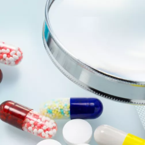 Image showing pills and a magnifying glass